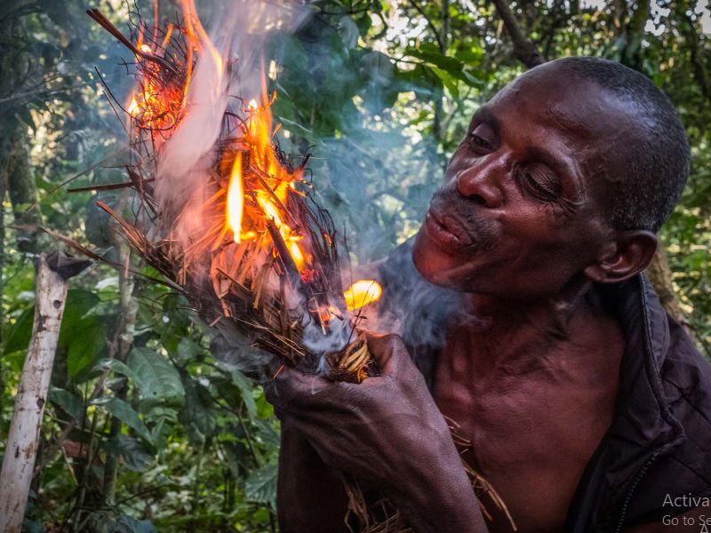 Batwa explaining how they used to make fire during the batwa trail experience.